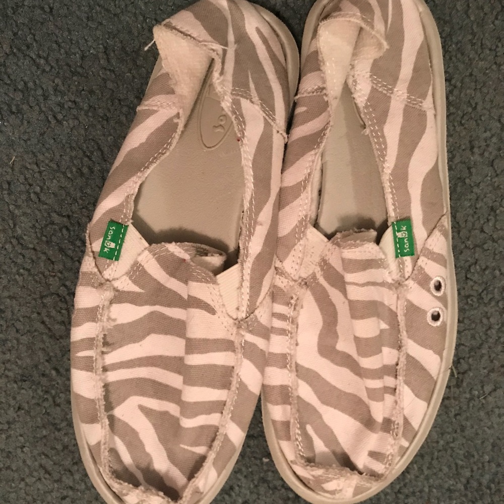 Gray and white Sanuk slip on shoes